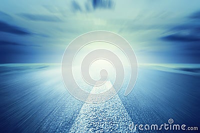 Long empty asphalt road towards light. Motion, speed Stock Photo