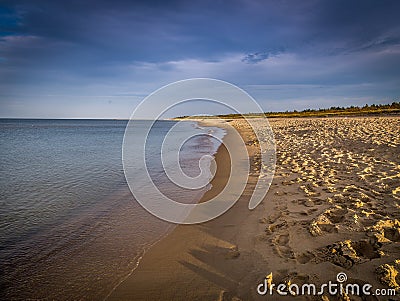 Long, empty and clean sand Stogi beach in the sunset near Gdansk, Poland with dramatic blue sky Stock Photo