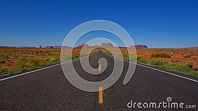 Long empty Road leading to Monument Valley landscape in Arizona USA Stock Photo