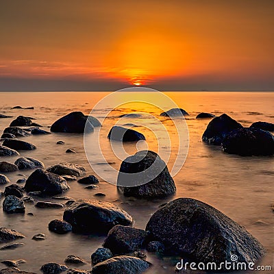 Long exposure of Baltic sea with beach stones during sunset, Dune island, Schonberg, Germany Stock Photo