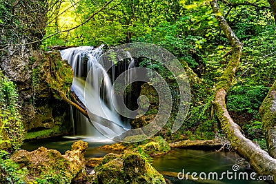 Long exposure of the beautiful La Vaioaga waterfall with green moss Stock Photo