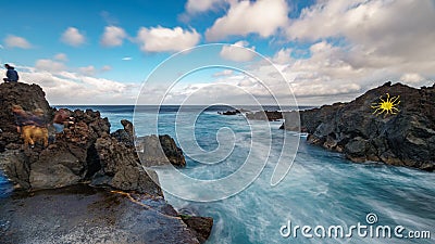 Long exposure of Biscoitos with volcanic rocks and tourists Stock Photo