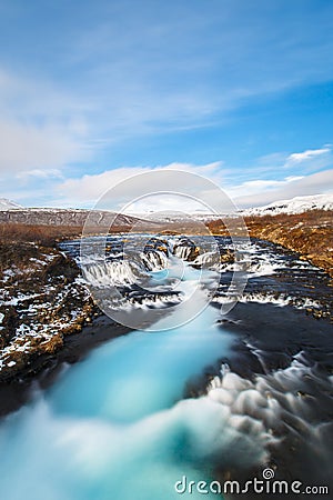 Long exposure of blue water at Bruarfoss waterfall Stock Photo