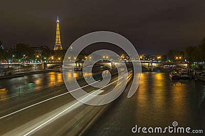 Long exposure of boats traffic in the Seine at night Editorial Stock Photo