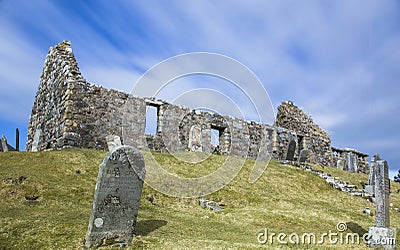Long exposure of clouds over a ruined chapel on a sunny day Stock Photo