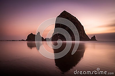 Long exposure of Haystack Rock at Sunset Stock Photo