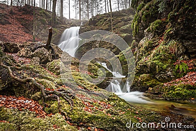 Long Exposure of Josefstaler Waterfall in Autumn Atmosphere in Bavaria, Germany Stock Photo