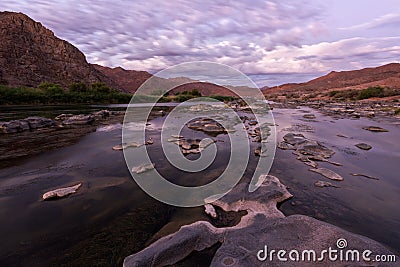 A long exposure landscape taken after sunset on the Orange River Stock Photo