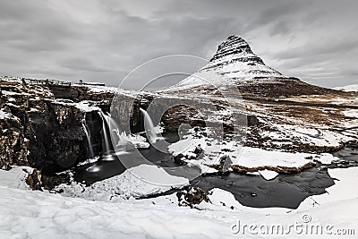 Long exposure of mountain with waterfall foreground in winter Stock Photo
