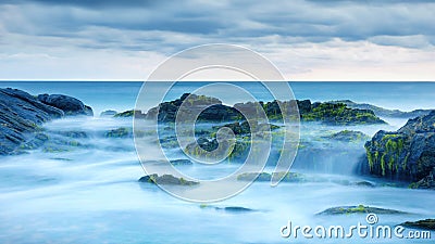 Long exposure of mystery ocean and rocks Stock Photo