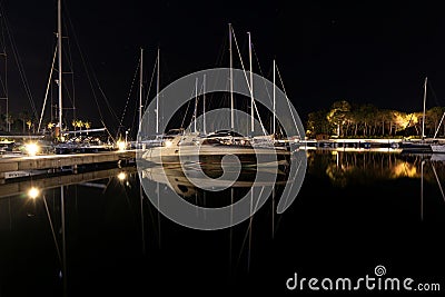 Long-exposure photo at a harbor, featuring a captivating view of boats and a beautiful reflection Stock Photo