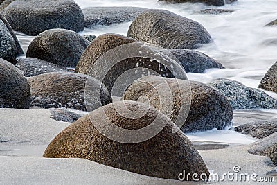 Long exposure of sea and stones on the beach Stock Photo