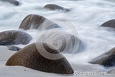 Long exposure of sea and stones on the beach Stock Photo