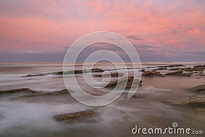 Long exposure seascape of a painterly sunset on a Florida beach. Stock Photo