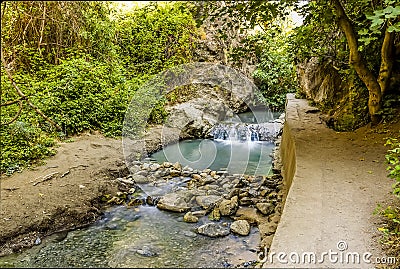 A long exposure shot of the Monachil river cascading over a small weir in the Sierra Nevada mountains, Spain Stock Photo