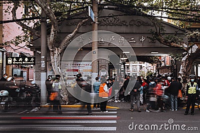 Long exposure shot of people and school kids rushing to school in front of the entrance in Shanghai Editorial Stock Photo