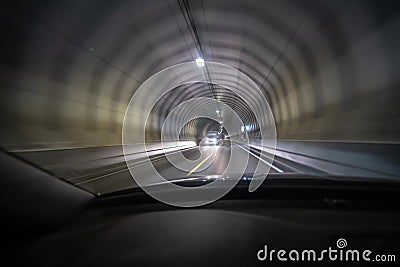 Long exposure shot of tunnel at Lofoten from inside a car that is moving so the light creates tunnel vision effect Stock Photo