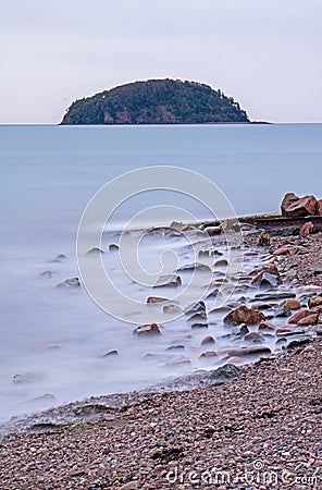 Long Exposure Of Spencer`s Island And Rocky Shoreline Stock Photo