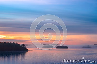 Long Exposure of Sunset at the Paijanne lake. Beautiful scape with sunrise sky, pine forest and water. Lake Paijanne, Finland Stock Photo