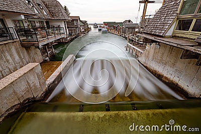 Long exposure of a tranquil river winding through a peaceful residential neighborhood in Fishtown Stock Photo