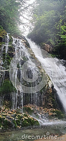 Long exposure vertical view of Urlatoarea Waterfall in the Bucegi Mountains, Romania Stock Photo