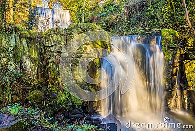 A long exposure view a pair of cascading waterfalls at Lumsdale on Bentley Brook, Derbyshire, UK Stock Photo