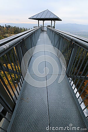Long metal outlook tower foot bridge high above trees Stock Photo