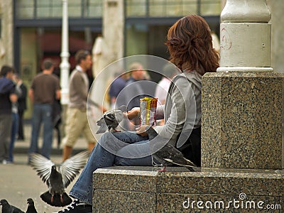 Long Hair Girl Feeding A Pidgeons Stock Photo