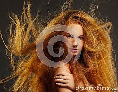 Long-haired curly redhead woman Stock Photo