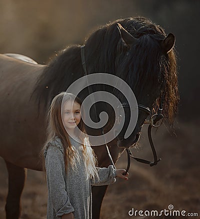 Long haired Little girl in casual style with brown horse Stock Photo