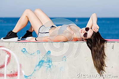 Long haired sportswoman lying on back and looking at camera Stock Photo