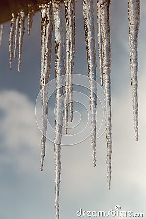Long icicles of ice on the roof of the house Stock Photo