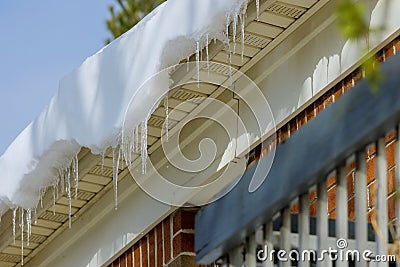 Long icicles at on roof house Stock Photo
