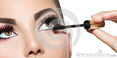 Long lashes closeup. Beautiful woman applying mascara on her eyes Stock Photo