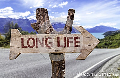 Long Life wooden sign with a street background Stock Photo