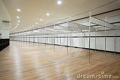 Long locker room with sectors from metallic pipes Stock Photo