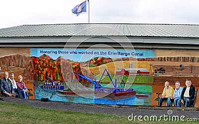 Long metal building with paintings depicting the people who worked on Erie Canal, Lyons New York, 2022 Editorial Stock Photo