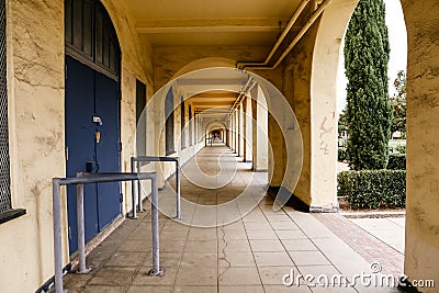 Long outdoor hall of old building with arches Stock Photo