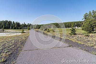 Long paved walking trail that leads from the Old Faithful area to the Morning Glory Pool in Yellowstone National Park Stock Photo