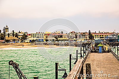 Long pier, walking people, residential houses on coastline of Swakopmund Editorial Stock Photo