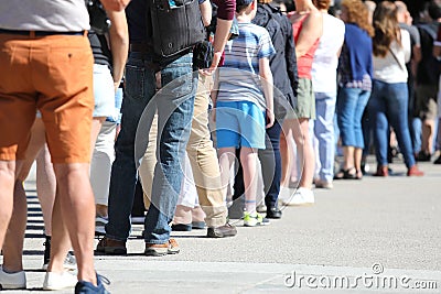 Long queue of people waiting in line Stock Photo