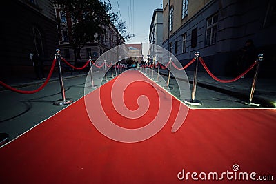 Long Red Carpet - is traditionally used to mark the route taken by heads of state on ceremonial and formal occasions Stock Photo