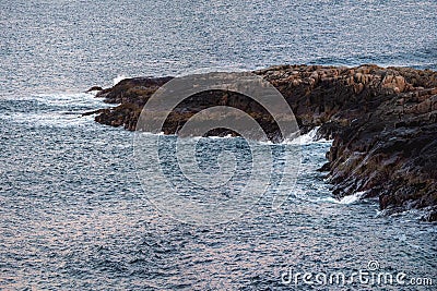 A long rocky cliff jutting out into the sea. Wonderful panoramic mountain landscape on the Barents sea Stock Photo