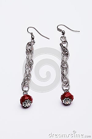 Long silver earrings with red gems Stock Photo