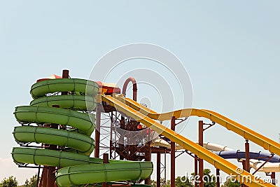 Long spiral and straight water slides in the outdoors seasonal water park at day time Stock Photo