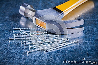 Long stainless construction nails with claw hammer Stock Photo