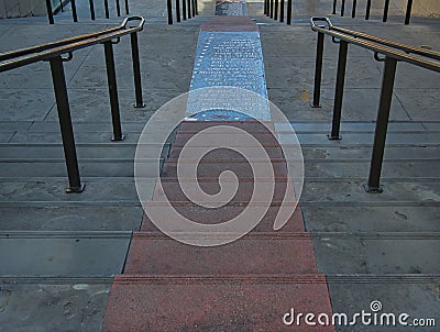 A long staircase with red steps in the middle Stock Photo