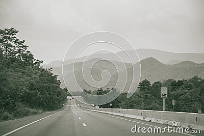 Long straight road with mountain view of countryside Stock Photo