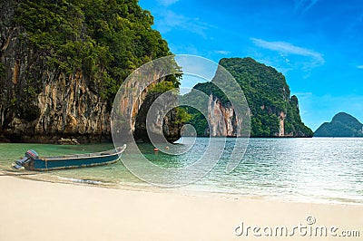 A long tail boat by the beach in Thailand Stock Photo