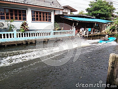 Long tail boat making water distribution Stock Photo